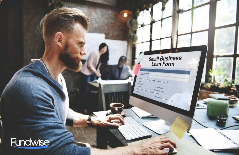 business owner filling up the small business loan form on his desktop