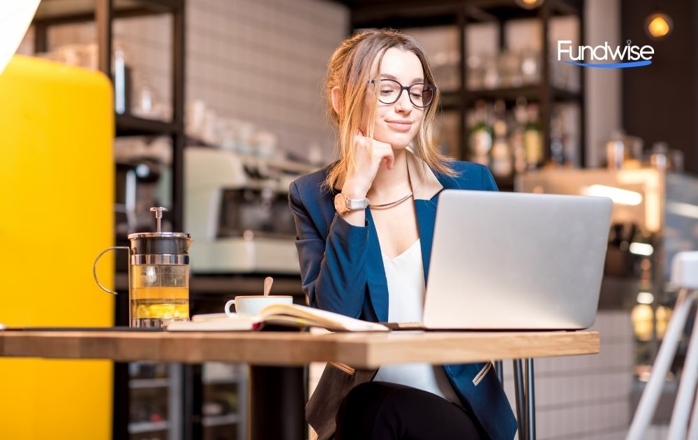 business owner using laptop in her shop