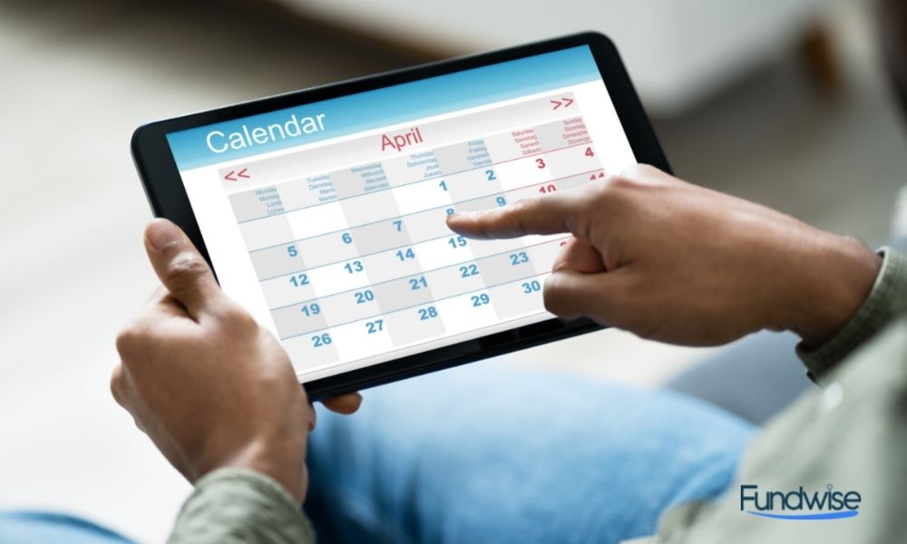 man looking at calendar in his digital tablet
