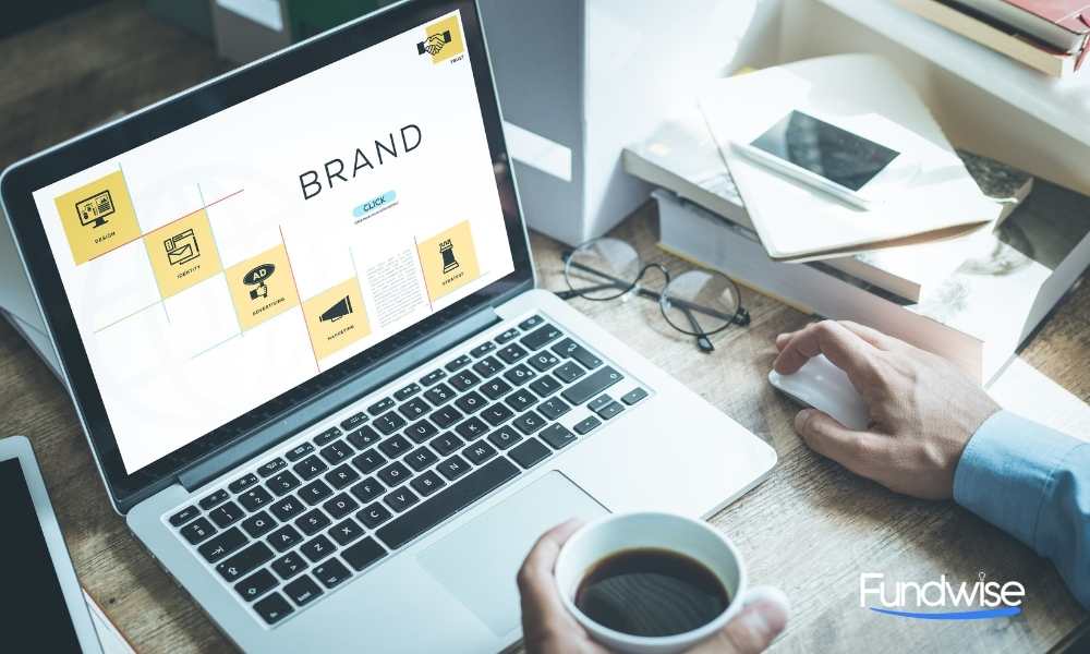 hand of a person doing branding on his laptop