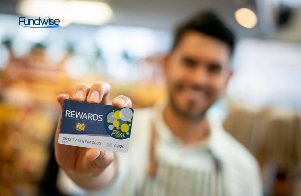 Business man at a store holding a loyalty program card up front